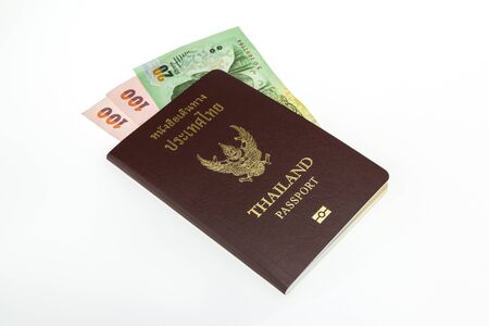 Thailand passport with Thai money  on white backgroundの写真素材