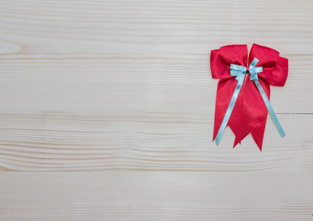 Red ribbons with tails on wood textureの写真素材