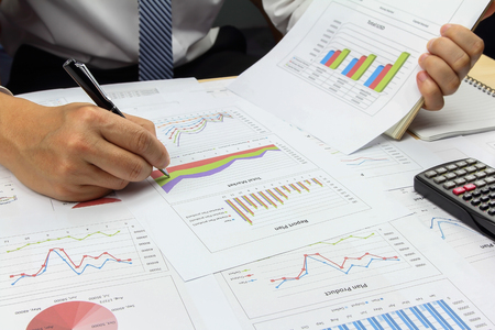 Businessman Summary report plan and financial analyzing product market plan, and Review accounting data and calculate order income.の写真素材