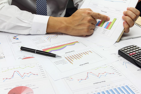 Businessman Summary report plan and financial analyzing product market plan, and Review accounting data and calculate order income.の写真素材