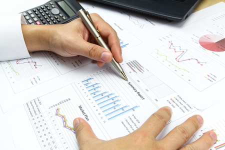 Businessman  Summary report and financial analyzing  market plan concept, calculator with on document paper.の写真素材