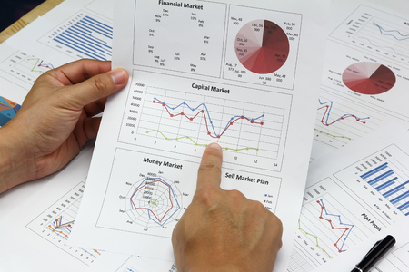 Businessman Summary report plan and financial analyzing capital market plan, and Review accounting data and calculate order income.の写真素材
