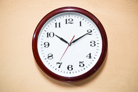 Red clock hanging at the wall. vintage style