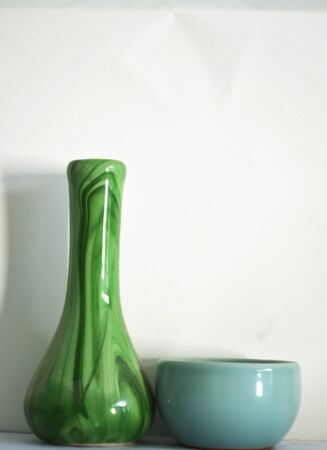 A green vase and blue small cup.の写真素材