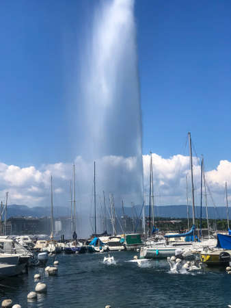 Beautiful View of famous Jet d'Eau fountain With blue sky, sea, boats and clouds at  Geneva, Switzerland on 8-August-2019のeditorial素材