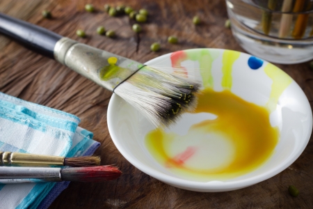 Painting brushes on an old painters desk の写真素材