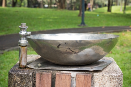 Water pours out of the open valveの写真素材