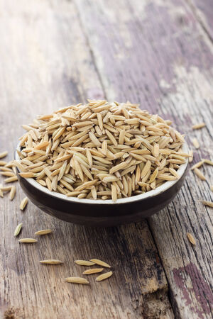 Paddy in brown wooden round oriental bowlの写真素材