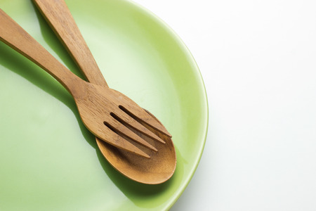 Empty plate, wooden spatula and spoon, concept, top viewの写真素材