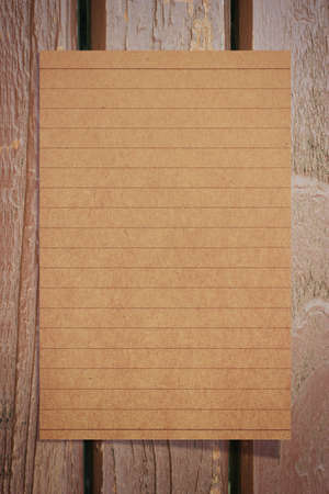 Notebook paper on a wooden floorの写真素材