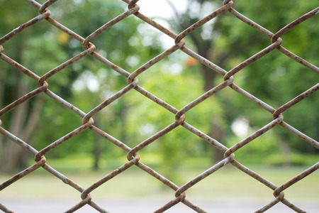 Wire fence with futsal field on backgroundの写真素材