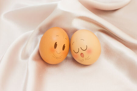 Eggs in Expression Face on satin and Colorful Background
