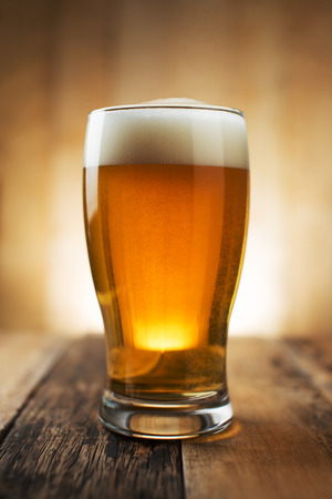 Glass beer on wood background with copyspaceの写真素材