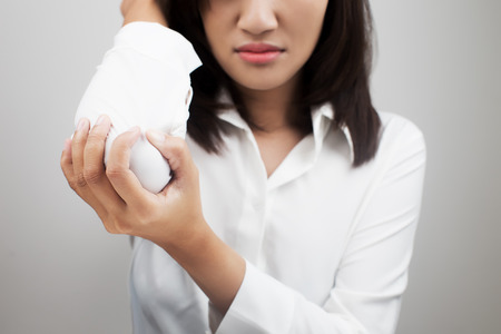 Business woman suffering from elbow painの写真素材