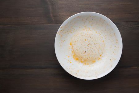 An empty plate, dirty after the meal is finished. View from above.の写真素材