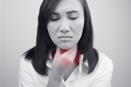 Sore throat woman on white backgroundの写真素材