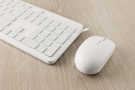 The white computer keyboard is in white packaging.