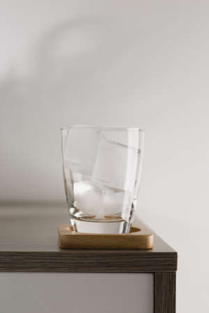 Ice cubes in glass on white wall background.の写真素材