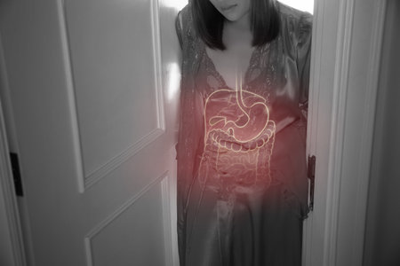 Asian woman touching stomach painful suffering from enteritis at night.