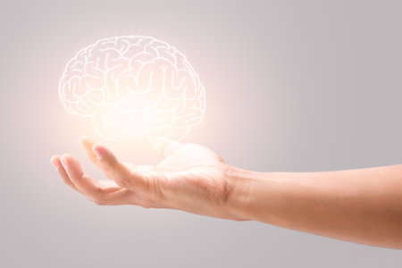 Man holding brain illustration against gray wall background. Concept with mental health protection...