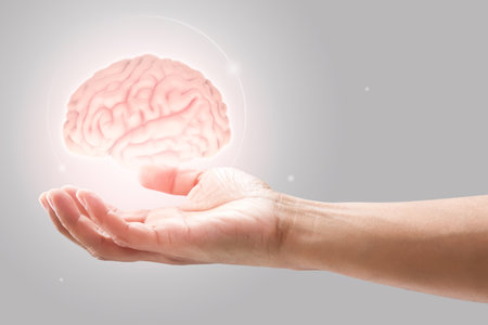 Man holding brain illustration against gray wall background. Concept with mental health protection...
