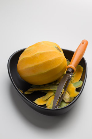 Mangoes peeled and placed in a black dish.の写真素材