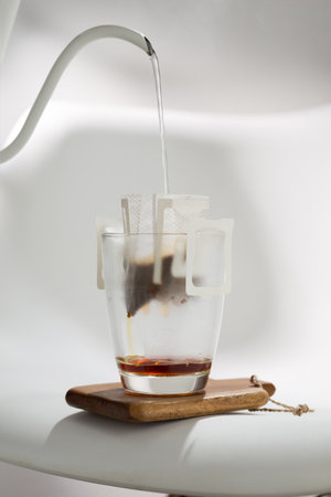 A Drip Bag methodically filters water through Coffee grounds, exemplifying precision in brewing techniques.の写真素材