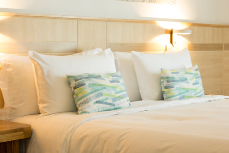 Sleek hotel room design features wood accents and transparent bathroom partition for a contemporary feel.の写真素材