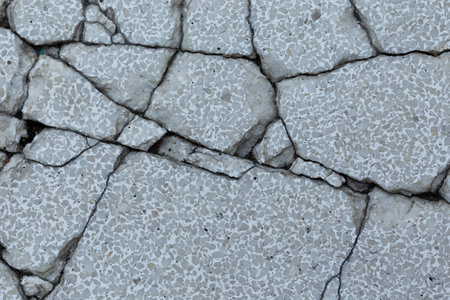 The cracked concrete surface indicates severe structural damage, raising concerns about the...
