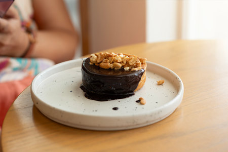 Indulge in this exquisite bakery creation: a rich chocolate dessert perfectly adorned with a...