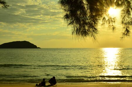 Beautiful sunset above the sea.Gold Sunset, sea and clouds. Beautiful golden orange sunset over the ocean. The sun sets turning the sky yellow, orange & red tones & reflects in the ocean.の写真素材