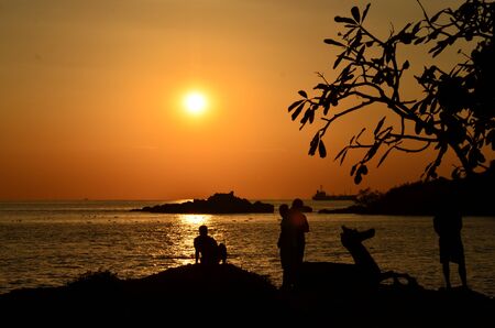 Beautiful sunset above the sea.Gold Sunset, sea and clouds. Beautiful golden orange sunset over the ocean. The sun sets turning the sky yellow, orange & red tones & reflects in the ocean.の写真素材
