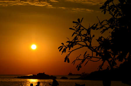 Beautiful sunset above the sea.Gold Sunset, sea and clouds. Beautiful golden orange sunset over the ocean. The sun sets turning the sky yellow, orange & red tones & reflects in the ocean.の写真素材