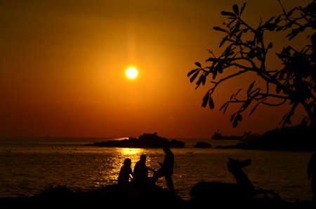 Beautiful sunset above the sea.Gold Sunset, sea and clouds. Beautiful golden orange sunset over the ocean. The sun sets turning the sky yellow, orange & red tones & reflects in the ocean.の写真素材
