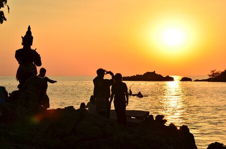 Beautiful sunset above the sea.Gold Sunset, sea and clouds. Beautiful golden orange sunset over the ocean. The sun sets turning the sky yellow, orange & red tones & reflects in the ocean.の写真素材