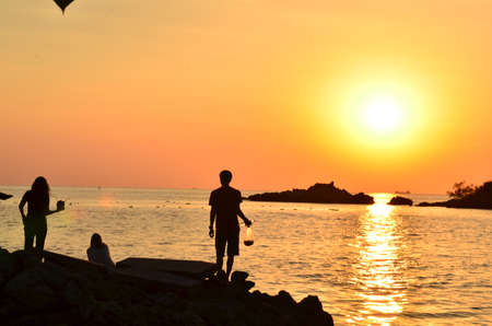 Beautiful sunset above the sea.Gold Sunset, sea and clouds. Beautiful golden orange sunset over the ocean. The sun sets turning the sky yellow, orange & red tones & reflects in the ocean.の写真素材