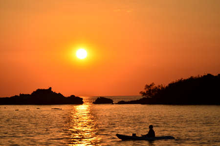 Beautiful sunset above the sea.Gold Sunset, sea and clouds. Beautiful golden orange sunset over the ocean. The sun sets turning the sky yellow, orange & red tones & reflects in the ocean.の写真素材