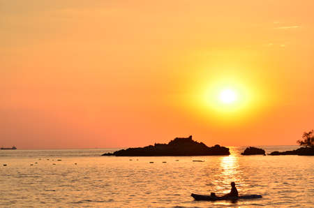 Beautiful sunset above the sea.Gold Sunset, sea and clouds. Beautiful golden orange sunset over the ocean. The sun sets turning the sky yellow, orange & red tones & reflects in the ocean.の写真素材