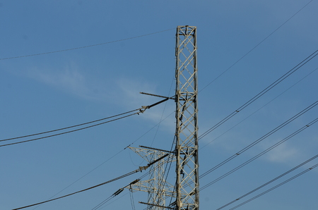 High-power tower Power transmission system.High voltage transmission line.high voltage pole Power transmission system With sky background image. High-voltage tower at blue sky background..の写真素材