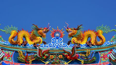 The roof and door of the shrine have a dragon statue. Chinese art in Thailand Chinese cultureの写真素材