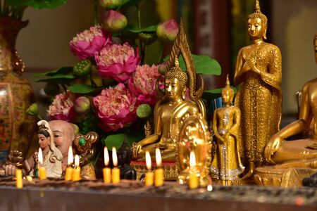 Beautiful Buddha image with candle light in Thai templeのeditorial素材