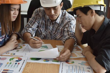 Architect with business man and engineer are planning on blueprint.の写真素材
