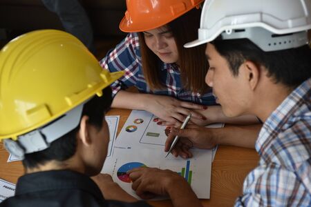 architect with business man and engineer are planning on document. Architect is pointing on the document. Selective focus at pointed hand.の写真素材