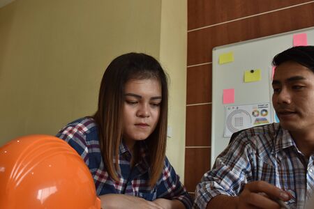 architect with business man and engineer are planning on document. Architect is pointing on the document. Selective focus at pointed hand.の写真素材