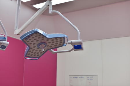 Surgical light in the operating room. Preparation for the beginning of surgical operation with a cut. Team surgeon at work in operating room.の写真素材