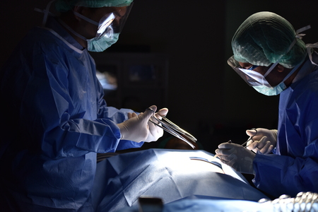 Surgical light in the operating room. Preparation for the beginning of surgical operation with a cut. Team surgeon at work in operating room.の写真素材