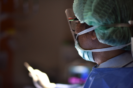 Surgical light in the operating room. Preparation for the beginning of surgical operation with a cut. Team surgeon at work in operating room.Innovative technology in a modern hospital operating room.の写真素材