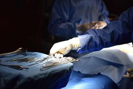 Surgical light in the operating room. Preparation for the beginning of surgical operation with a cut. Team surgeon at work in operating room.の写真素材