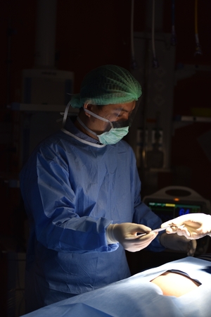 Surgical light in the operating room. Preparation for the beginning of surgical operation with a cut. Team surgeon at work in operating room.の写真素材