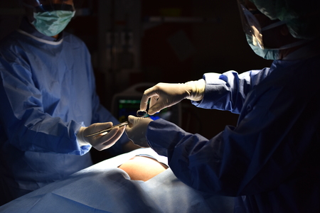 Surgical light in the operating room. Preparation for the beginning of surgical operation with a cut. Team surgeon at work in operating room.の写真素材